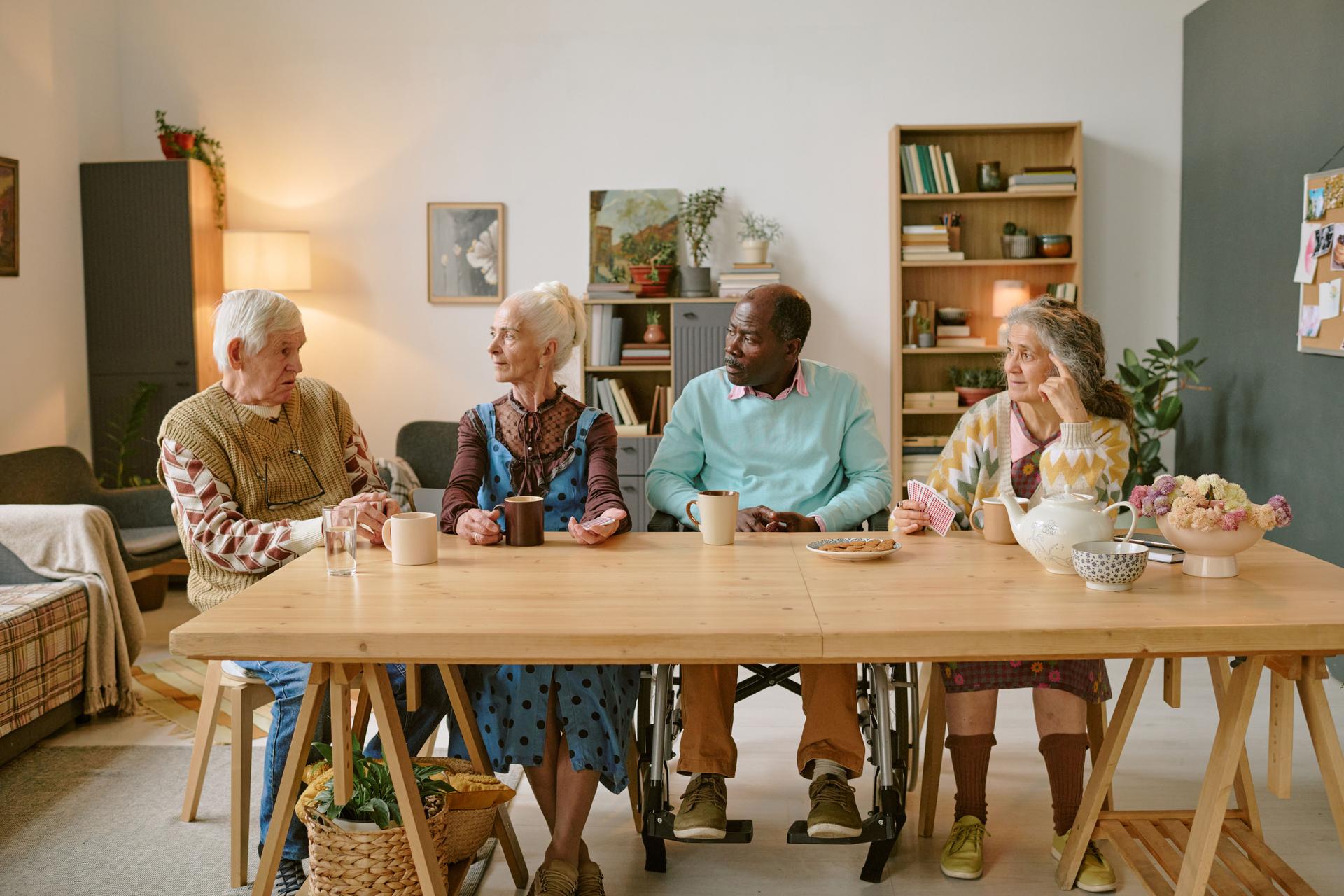 Residents of Nursing Home Chatting at table