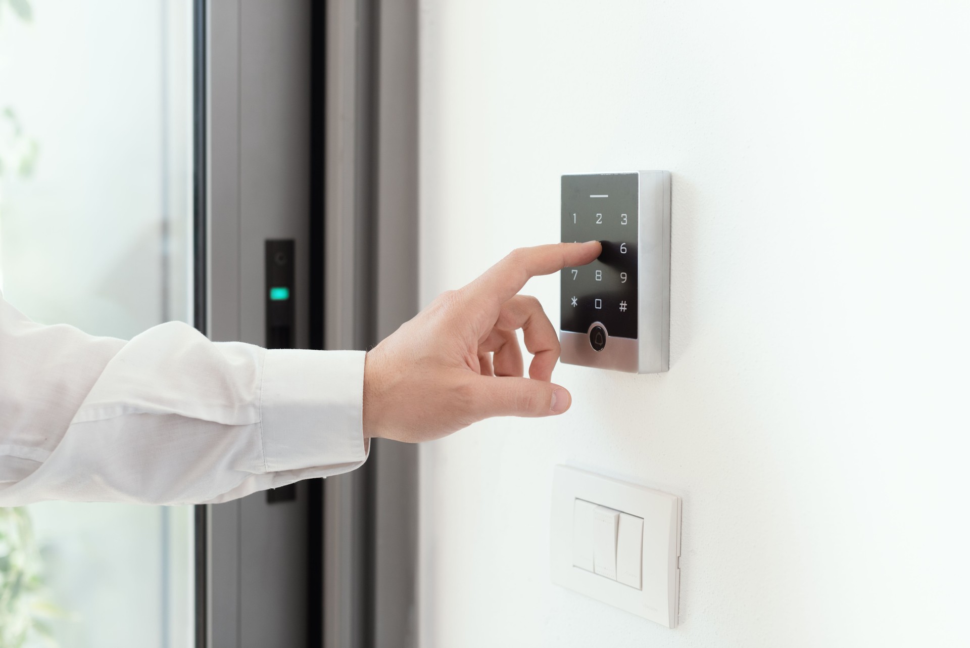Man setting an alarm code for home security